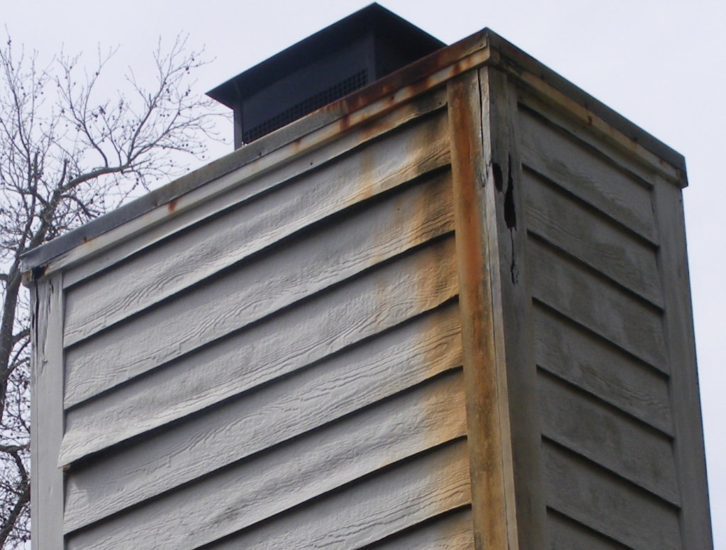 Improperly maintained chimney caps lead to decay of the siding and trim as well as severe rust stains leaching onto the underlying siding